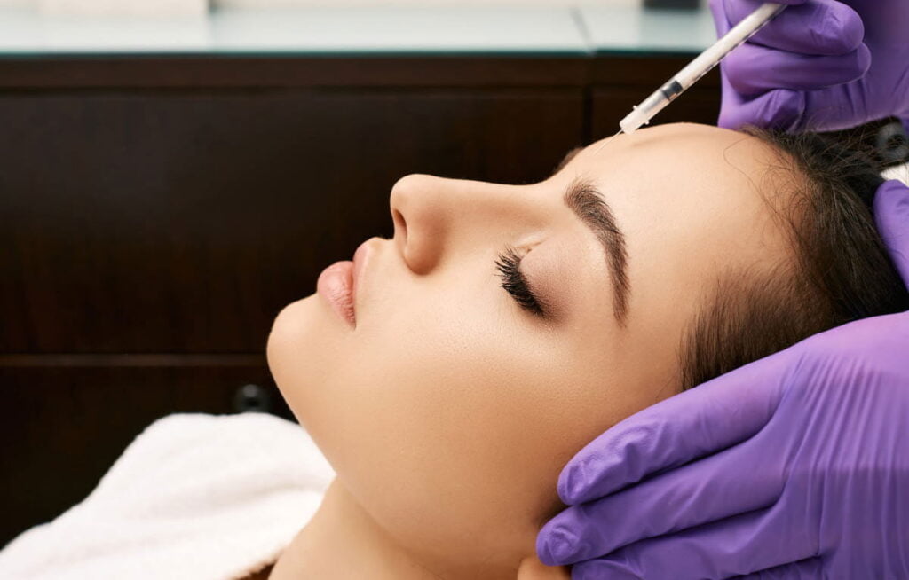 Woman Getting BOTOX Cosmetic Injections at medical spa