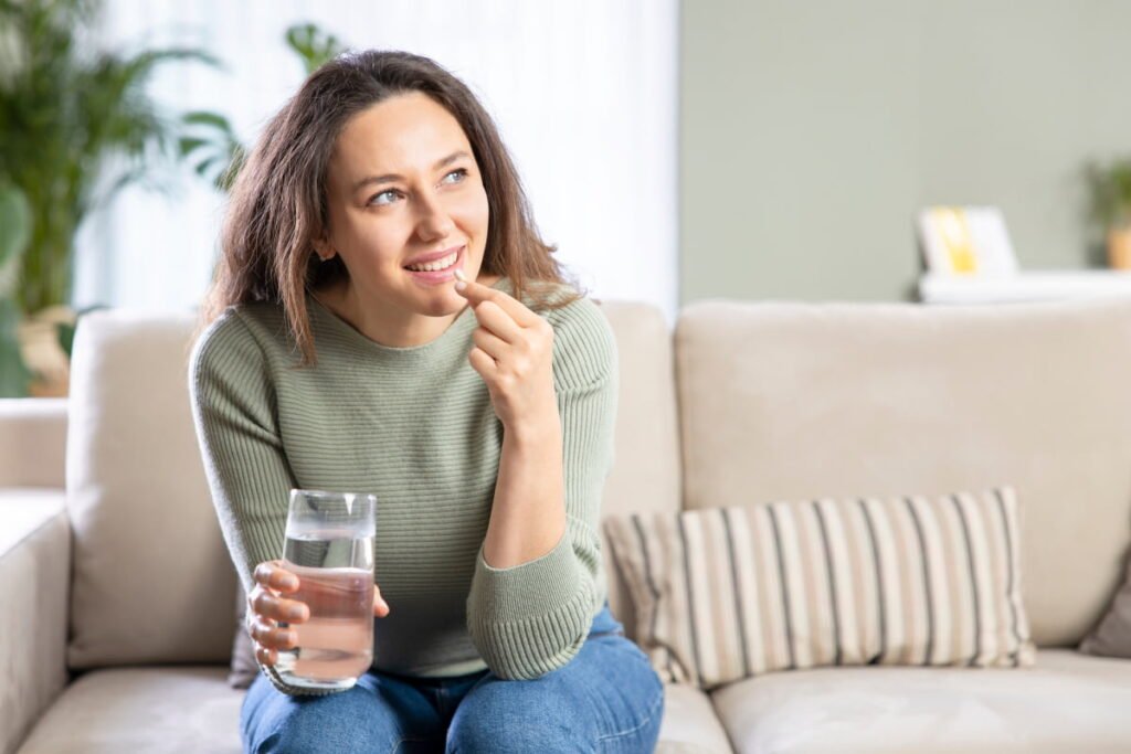 Smiling woman taking Advil for minor aches and pains