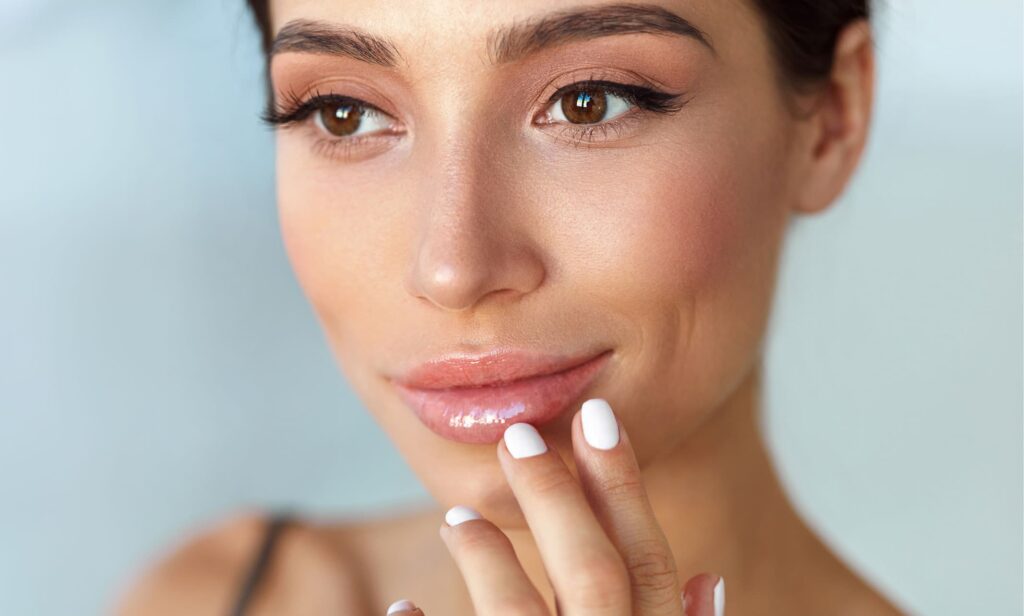 Woman touching her lips after having fillers dissolved