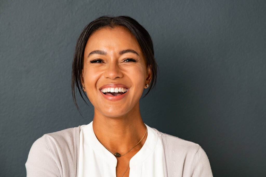 Woman in her early 40s smiling at the camera