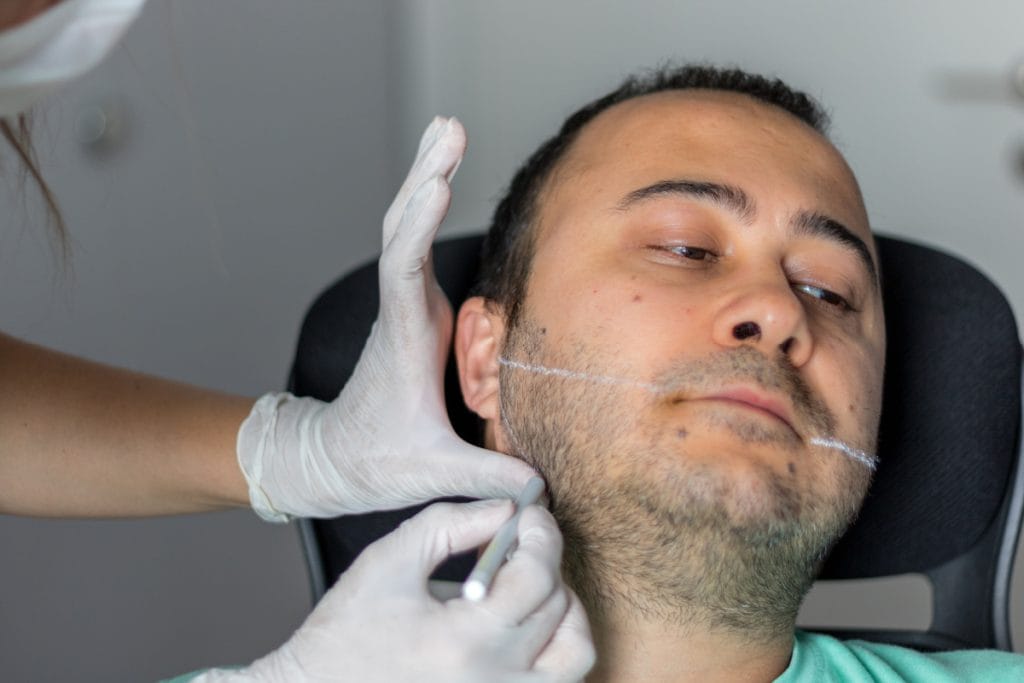 Man getting Kybella injections to treat a double chin