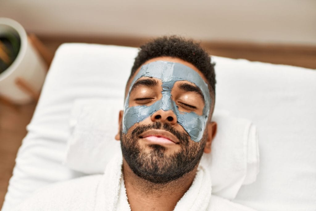 Man smiling and relaxing during a custom facial at a med spa